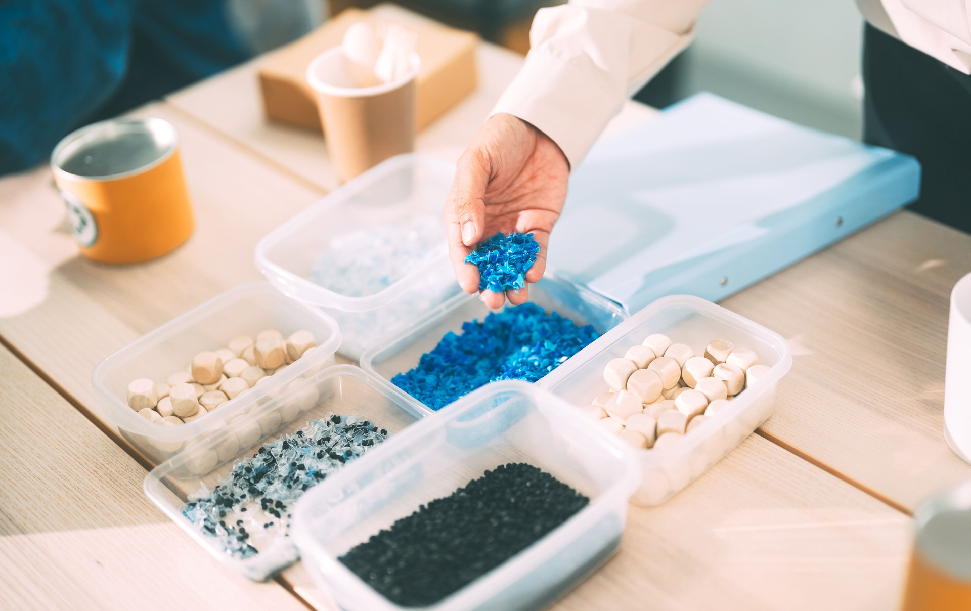 Man hand holding granulate plastic material for recycle sustainable living